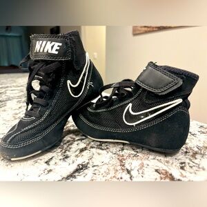 Black and white Nike youth wrestling shoes. Minimal wear. Size 12c